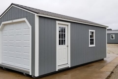 portable garage with grey wood panels and a window with an overhead garage door in cuba mo