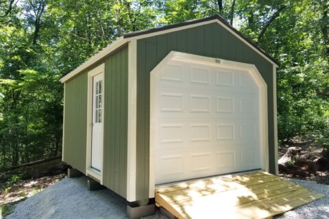 green portable wooden garages in mo with a white overhead door and sidedoor